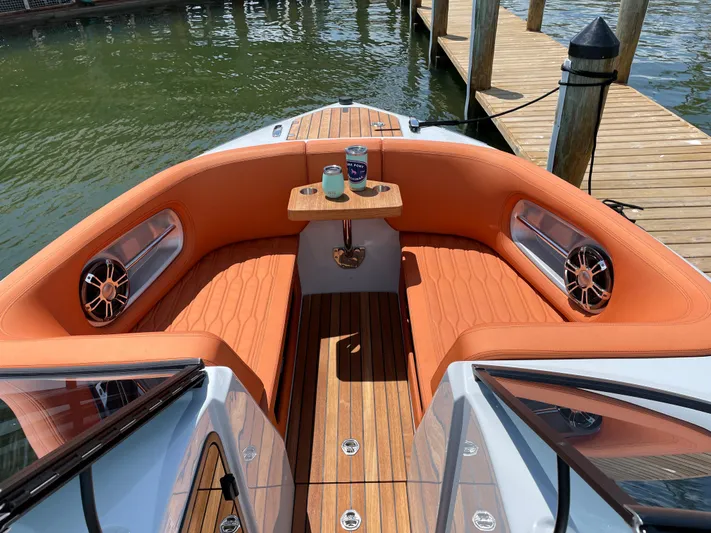 #0063 Bianca Panarea Yacht Photos Pics 2022 Cranchi 26 Rider boat with orange seating and wooden deck by the dock.