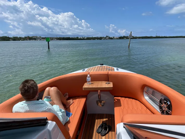 #0063 Bianca Panarea Yacht Photos Pics Man relaxing on 2022 Cranchi 26 Rider boat, enjoying sunny day on the water.