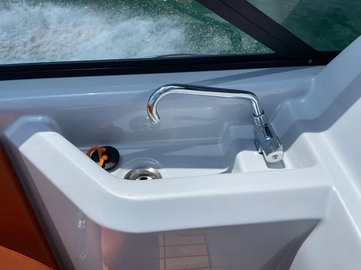 #0063 Bianca Panarea Yacht Photos Pics Cranchi 26 Rider 2022 boat sink with chrome faucet and water view.