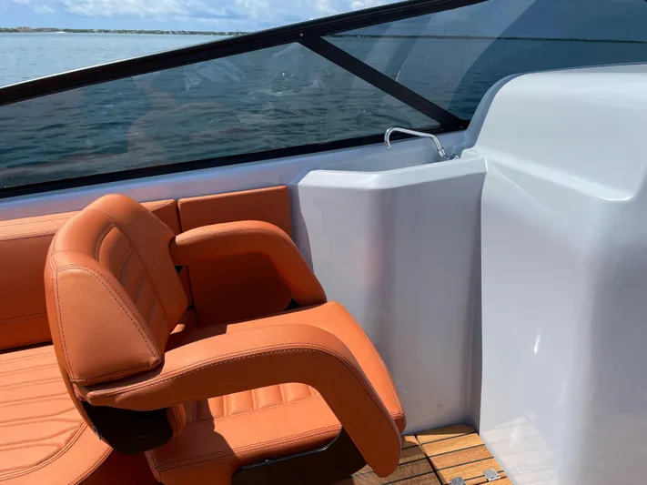 #0063 Bianca Panarea Yacht Photos Pics 2022 Cranchi 26 Rider boat interior with orange seating and sleek design.