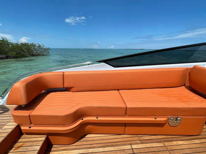#0063 Bianca Panarea Yacht Photos Pics 2022 Cranchi 26 Rider boat with orange seating, wooden deck, and ocean view.