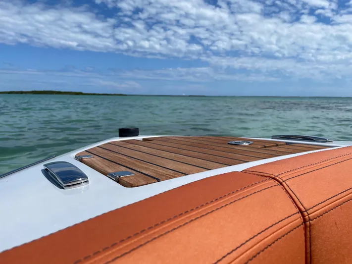 #0063 Bianca Panarea Yacht Photos Pics 2022 Cranchi 26 Rider boat on calm water under a partly cloudy sky.