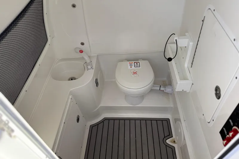  Yacht Photos Pics 2021 Sea Hunt Ultra 305 SE boat bathroom with toilet and sink.