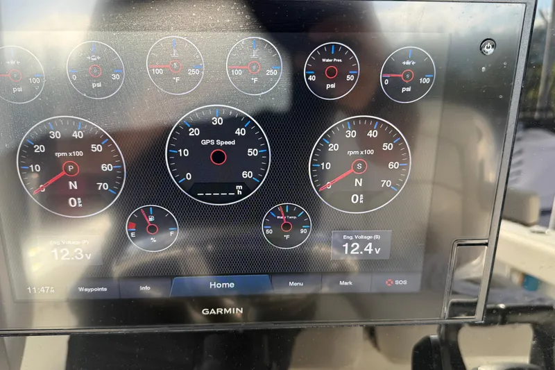  Yacht Photos Pics 2021 Sea Hunt Ultra 305 SE dashboard with Garmin display showing gauges and engine voltage.