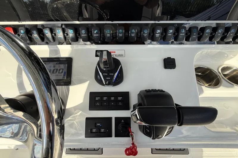  Yacht Photos Pics Control panel of 2021 Sea Hunt Ultra 305 SE boat with steering wheel and switches.