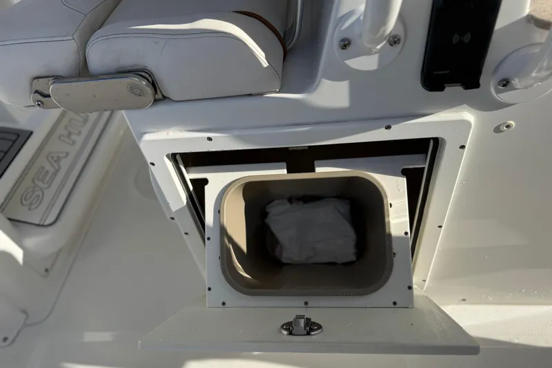  Yacht Photos Pics 2021 Sea Hunt Ultra 305 SE boat storage compartment with cushioned seating.