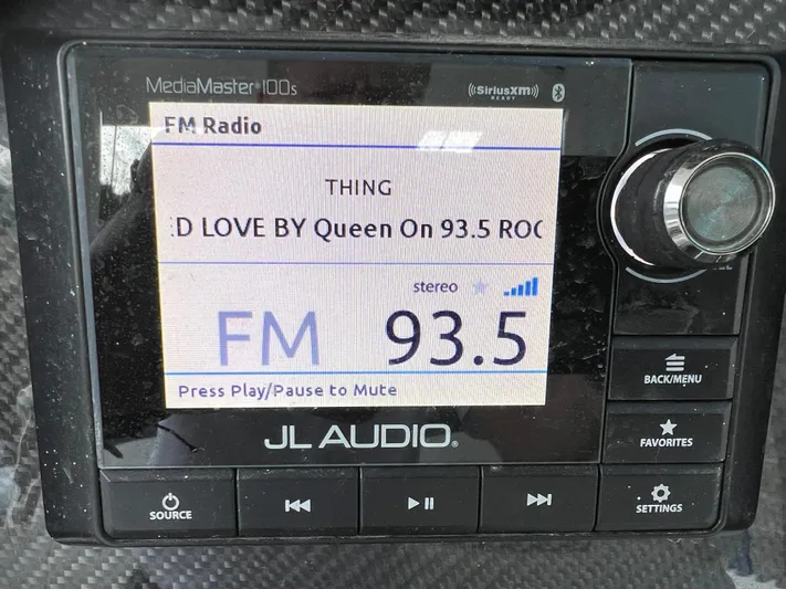 Perseverance Yacht Photos Pics JL Audio MediaMaster display showing FM 93.5 playing Queen's "Crazy Little Thing Called Love."
