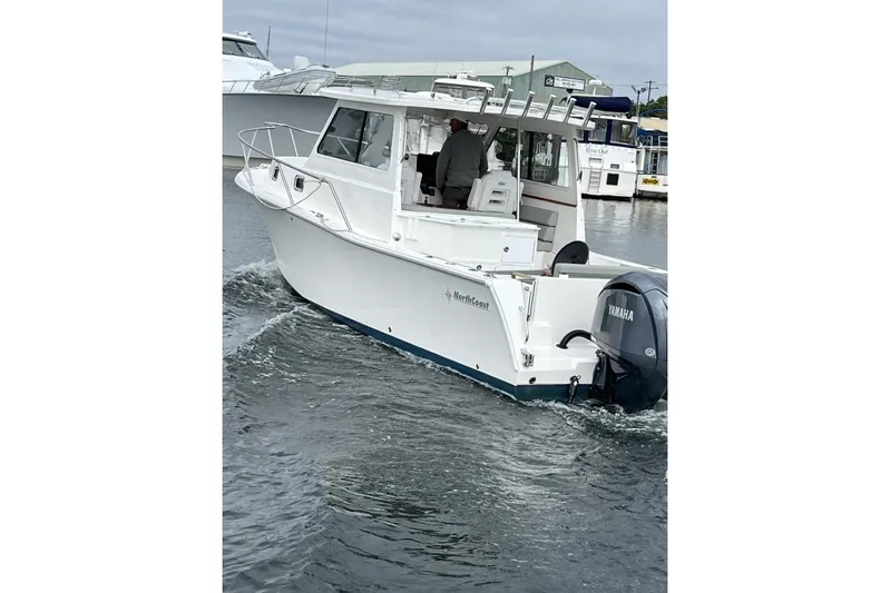  Yacht Photos Pics 2024 NorthCoast 285HT boat with Yamaha engine cruising in a marina.