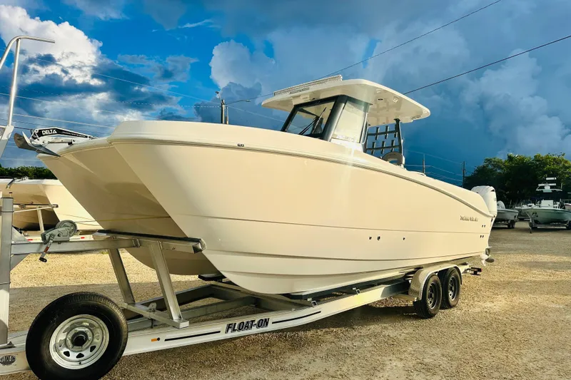  Yacht Photos Pics 2025 Twin Vee 260 GFX2 CC boat on trailer under dramatic cloudy sky.