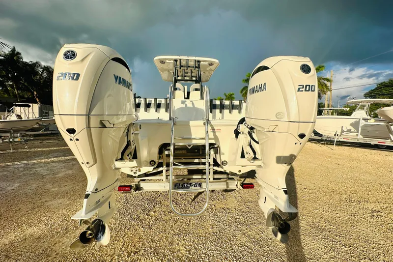  Yacht Photos Pics 2025 Twin Vee 260 GFX2 CC boat with dual Yamaha 200 engines, parked outdoors.