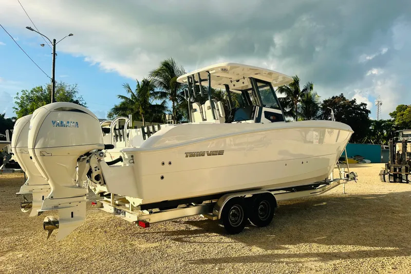  Yacht Photos Pics 2025 Twin Vee 260 GFX2 CC boat with Yamaha engines on a trailer, parked outdoors.