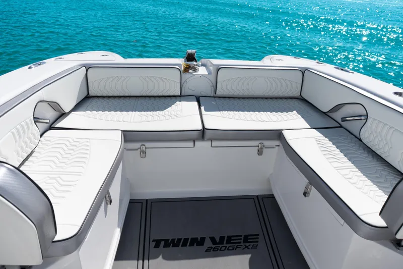  Yacht Photos Pics 2025 Twin Vee 260 GFX2 CC boat interior with white seating, ocean backdrop.
