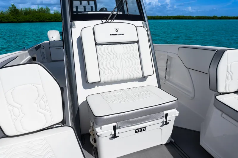  Yacht Photos Pics 2025 Twin Vee 260 GFX2 CC boat interior with white cushioned seating and Yeti cooler.