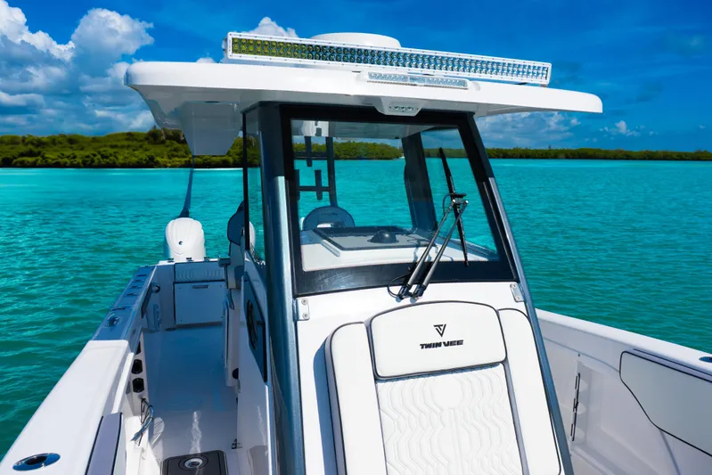  Yacht Photos Pics 2025 Twin Vee 260 GFX2 CC boat on turquoise water under clear blue sky.