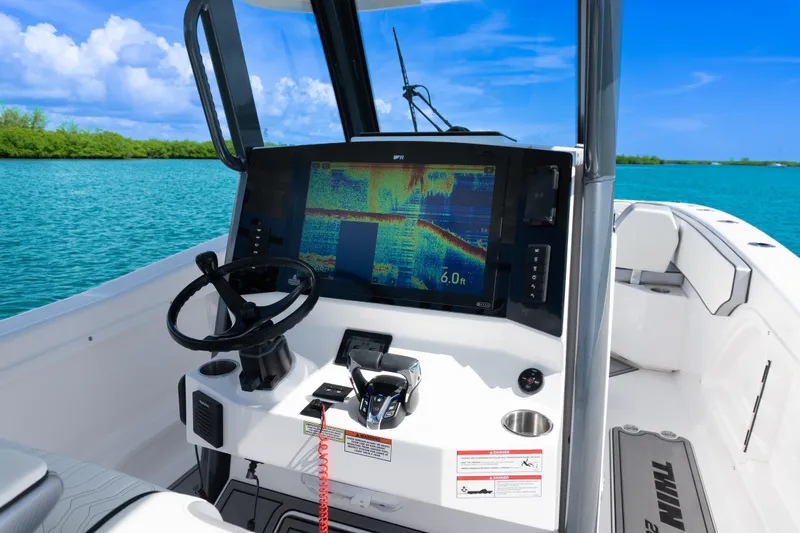  Yacht Photos Pics 2025 Twin Vee 260 GFX2 CC boat dashboard with navigation display on serene blue water.