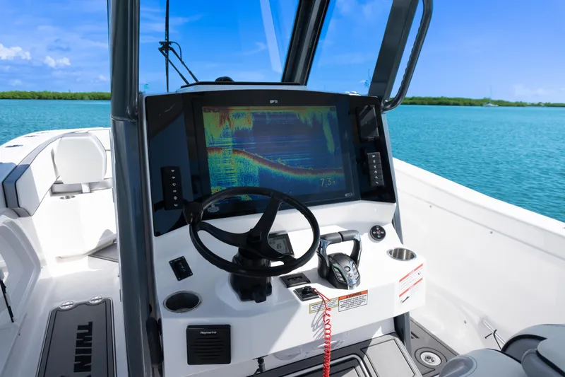  Yacht Photos Pics 2025 Twin Vee 260 GFX2 CC boat dashboard with advanced navigation system on open water.