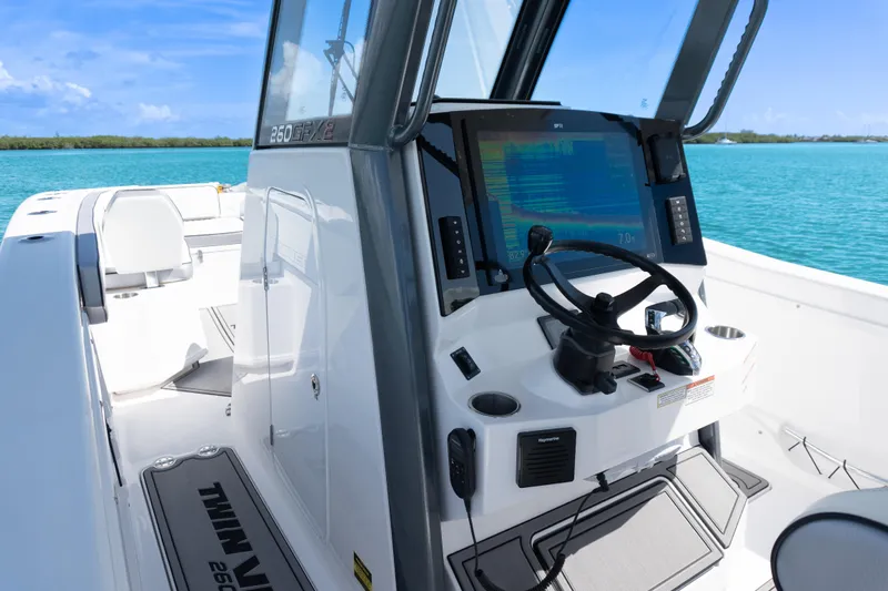  Yacht Photos Pics 2025 Twin Vee 260 GFX2 CC boat interior with steering console and navigation display.