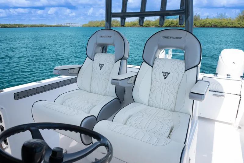  Yacht Photos Pics 2025 Twin Vee 260 GFX2 CC boat interior with luxurious seating on a serene water backdrop.