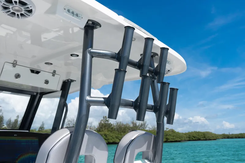  Yacht Photos Pics 2025 Twin Vee 260 GFX2 CC boat with rod holders, under clear blue sky.