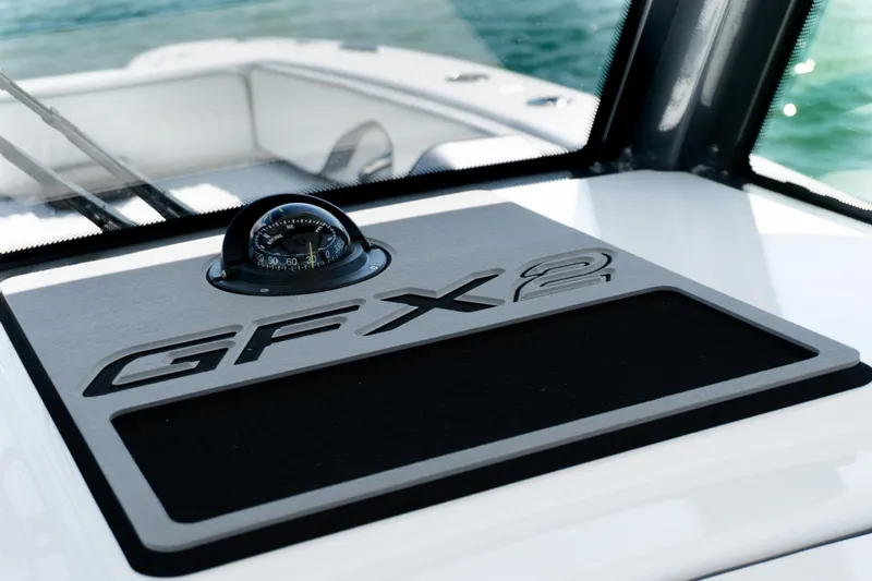  Yacht Photos Pics 2025 Twin Vee 260 GFX2 CC boat dashboard with compass, sleek design.