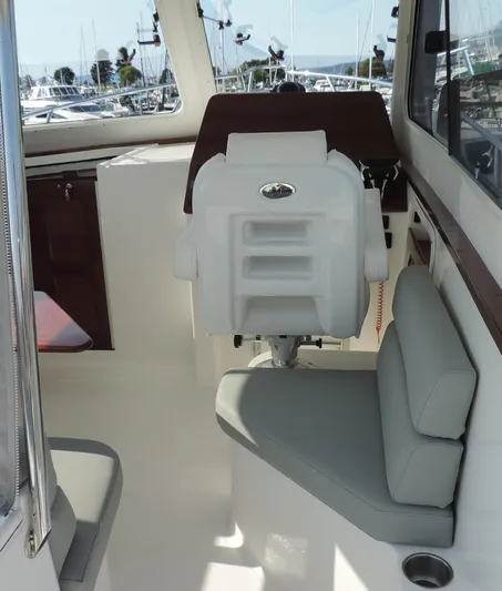  Yacht Photos Pics 2024 NorthCoast 285HT boat interior with seating and helm station.