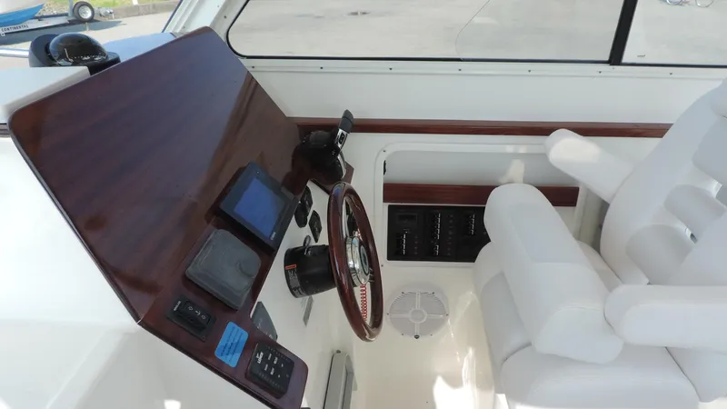  Yacht Photos Pics 2024 NorthCoast 285HT boat helm with modern controls and white seating.