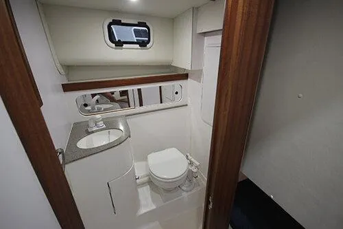  Yacht Photos Pics 2024 NorthCoast 285HT boat bathroom with sink, toilet, and porthole window.