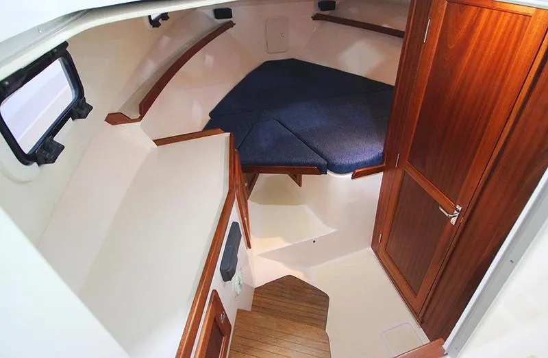  Yacht Photos Pics 2024 NorthCoast 285HT cabin interior with wood accents and blue cushions.