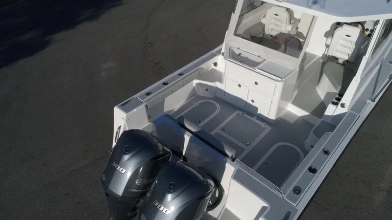  Yacht Photos Pics 2024 NorthCoast 285HT boat with dual 300 horsepower engines, spacious deck, and seating area.