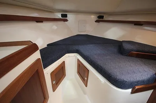  Yacht Photos Pics 2024 NorthCoast 285HT cabin interior with blue cushions and wooden accents.