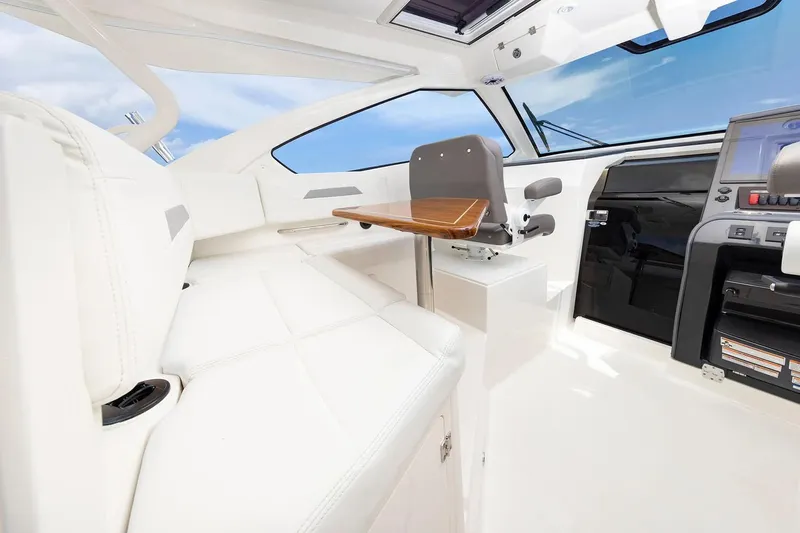  Yacht Photos Pics Manufacturer Provided Image: Luxurious interior of 2025 Pursuit OS 405 Offshore boat with white seating and modern controls.