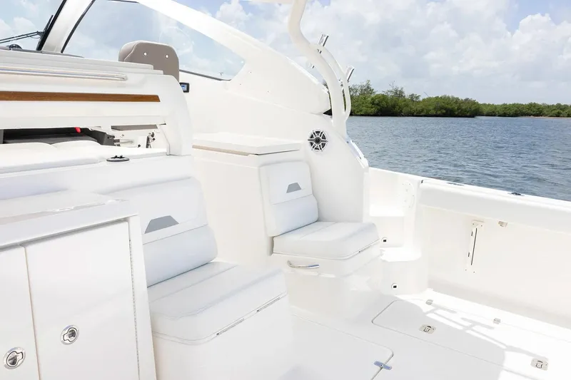  Yacht Photos Pics Manufacturer Provided Image: 2025 Pursuit OS 405 Offshore boat interior with white seating, near calm waters.