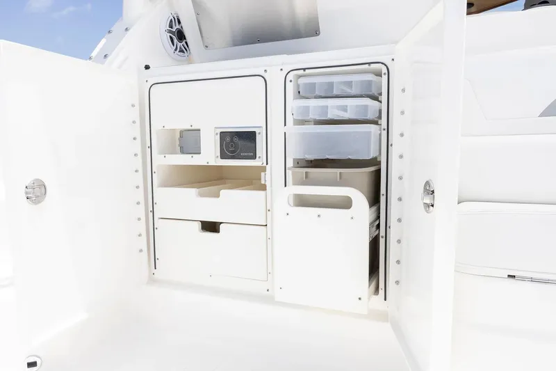  Yacht Photos Pics Manufacturer Provided Image: 2025 Pursuit OS 405 Offshore boat storage compartment with organized shelves and drawers.