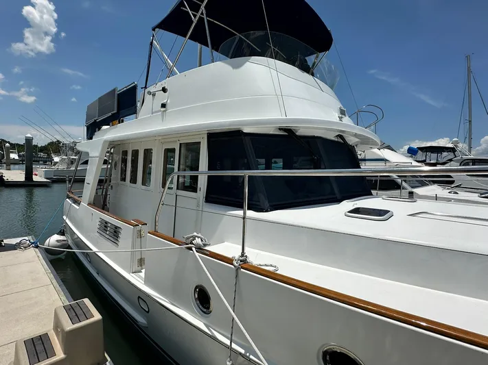 C'est Bon Yacht Photos Pics 2005 Beneteau Swift Trawler 42 docked at marina under clear blue sky.
