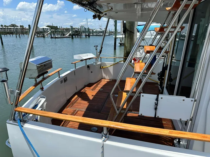 C'est Bon Yacht Photos Pics 2005 Beneteau Swift Trawler 42, wooden deck, docked at marina, sunny day.