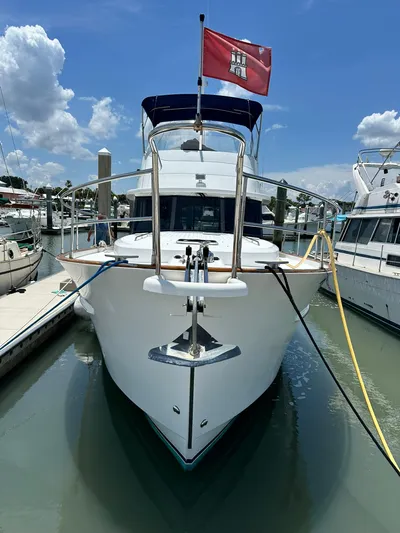 C'est Bon Yacht Photos Pics 2005 Beneteau Swift Trawler 42 docked, front view with flag, under blue sky.