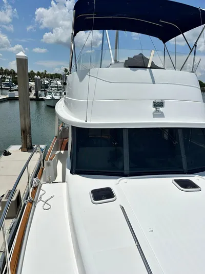 C'est Bon Yacht Photos Pics 2005 Beneteau Swift Trawler 42 docked at marina under blue sky.