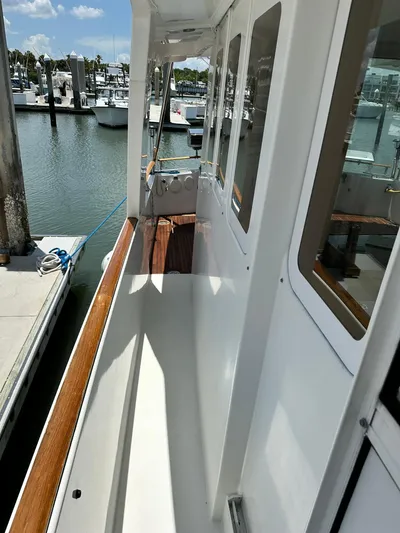 C'est Bon Yacht Photos Pics 2005 Beneteau Swift Trawler 42 docked, showcasing side deck and marina view.