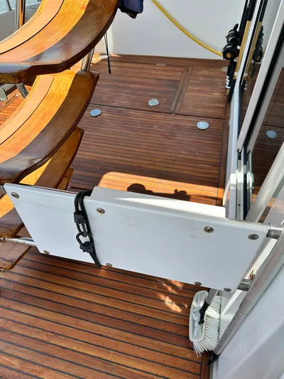 C'est Bon Yacht Photos Pics Wooden deck of a 2005 Beneteau Swift Trawler 42 with seating and safety gate.