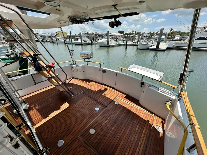 C'est Bon Yacht Photos Pics 2005 Beneteau Swift Trawler 42 with wooden deck, docked at marina under clear skies.