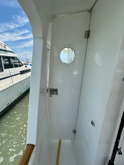 C'est Bon Yacht Photos Pics 2005 Beneteau Swift Trawler 42, exterior view with porthole and docked boats.