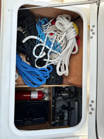 C'est Bon Yacht Photos Pics Storage compartment with ropes and fire extinguisher on a 2005 Beneteau Swift Trawler 42.