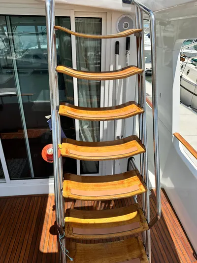 C'est Bon Yacht Photos Pics Staircase on 2005 Beneteau Swift Trawler 42 with wooden steps and metal railing.