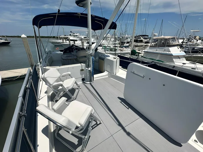 C'est Bon Yacht Photos Pics 2005 Beneteau Swift Trawler 42 on deck, featuring seating and marina view.