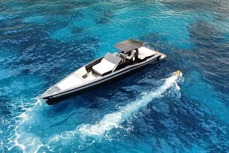  Yacht Photos Pics Maori 50 T-Top 2008 yacht cruising in clear blue ocean waters.