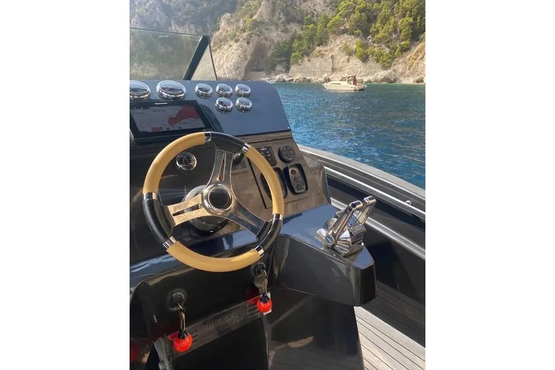  Yacht Photos Pics Steering console of 2008 Maori 50 T-Top yacht with scenic coastal view.