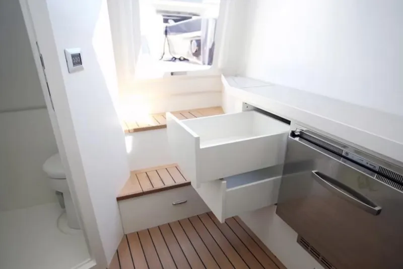  Yacht Photos Pics Interior of 2008 Maori 50 T-Top yacht with open drawer and wooden flooring.