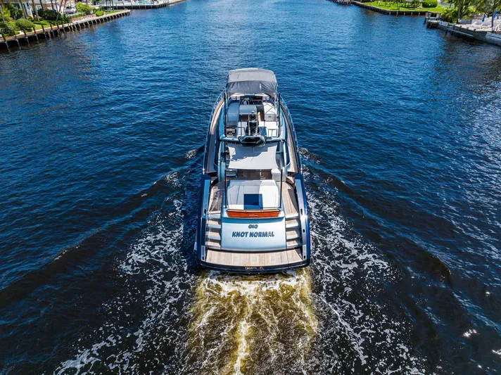 Knot Normal Yacht Photos Pics Aerial view of 2020 Riva 66' Ribelle luxury yacht cruising on a waterway.