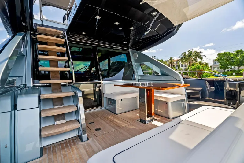 Knot Normal Yacht Photos Pics Luxury yacht Riva 66' Ribelle 2020 model, featuring elegant outdoor seating and wooden staircase.