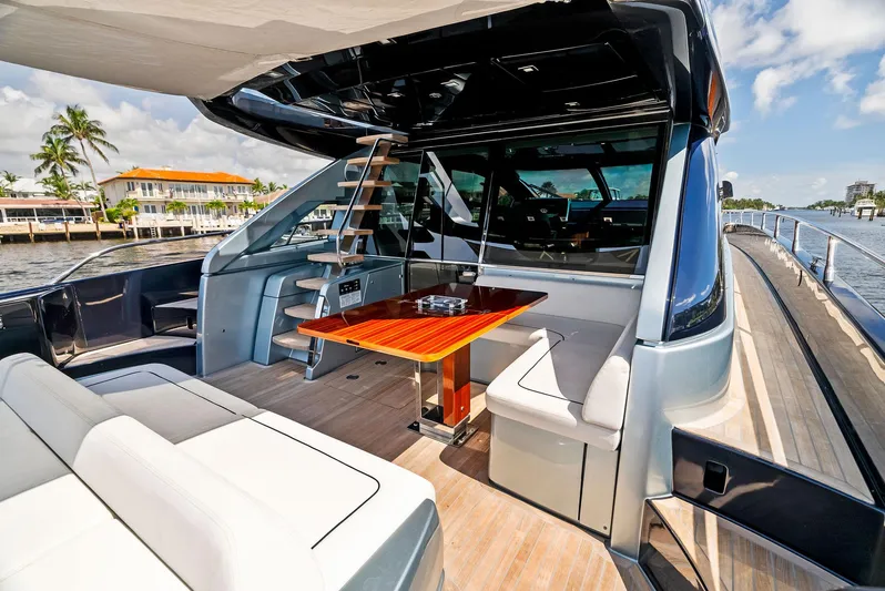 Knot Normal Yacht Photos Pics 2020 Riva 66' Ribelle yacht with luxurious outdoor seating and dining area.